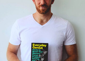 Author and memory champ Nelson Dellis holds a copy of his book, which is due out in 2026. Dellis studied Taylor Swift's entire discography over the summer, committing it to memory.