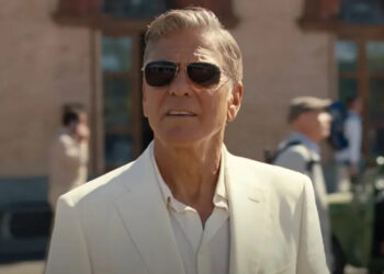 George Clooney as Jay Kelly, watches from behind shades as his daughter drives away on a bus. .