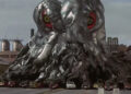 Hedorah eating up some cars outside a factory in Godzilla vs. Hedorah