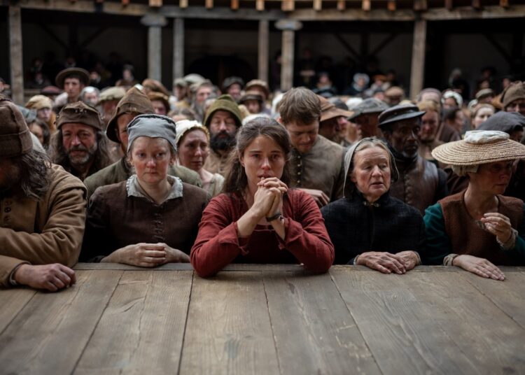 Shakespeare's wife surrounded by groundlings in the theater