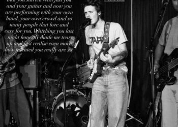 A black and white photo of Cruz Beckham performing on stage