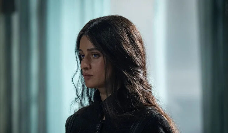 Anya Chalotra's Yennefer stands against a blurred background in The Witcher