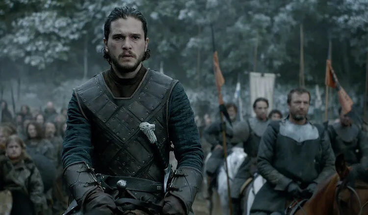 Jon Snow (Kit Harington) mounted on horseback with a small force at his back in Game of Thrones