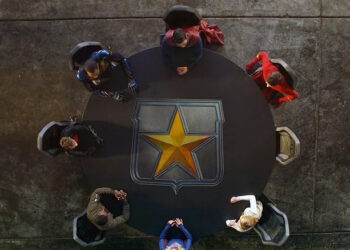 The seven members of The League assembles around a table in Crisis on Infinite Earths: Part Five