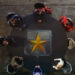 The seven members of The League assembles around a table in Crisis on Infinite Earths: Part Five