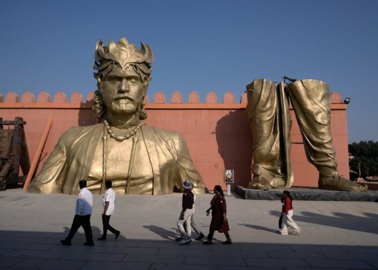 Visitors walk past the set of Bahubali in Ramoji Film City, in Hyderabad, India, Tuesday, Nov. 18, 2025. (AP Photo/Mahesh Kumar A.)