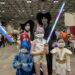 Cassandra Wheeler, left, and her husband, Josh, cosplay as characters from the movie “K-Pop Demon Hunters” during Planet Anime at the Kansas City Convention Center on Saturday, Nov. 22, 2025.
