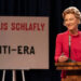 Phyllis Schlafly (Cate Blanchett) in front of a sign against the ERA on Mrs. America