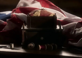 A screenshot from The American Revolution of a flag being sewn.
