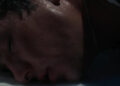 Barry Keoghan's Oliver Quick lays his head on the floor of a bathtub in Saltburn