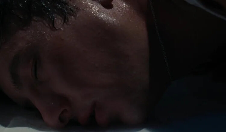 Barry Keoghan's Oliver Quick lays his head on the floor of a bathtub in Saltburn