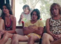 Bec, Liam, and Cal sitting on a couch, with Rooster standing behind in "Swinging Safari"