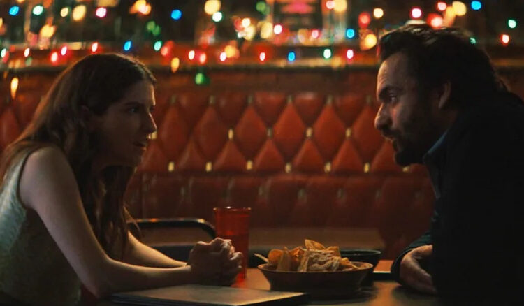 Anna Kendrick's Maddy sits opposite Jake Johnson's Tommy in a bar in Self Reliance
