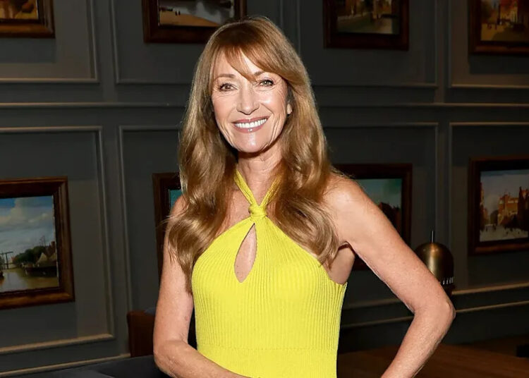 Jane Seymour smiling in a yellow halter dress