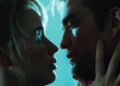 Grace touches Jackson's face leaning in to kiss in