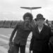 Jimi Hendrix poses with a fellow passenger on the runway as he arrives at Hamburg airport on Sept. 5, 1970. (AP Photo/Helmuth Lohmann)