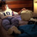 Glen Lantz sits on his bed while wearing headphones in "A Nightmare on Elm Street" (1984)