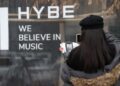 A visitor takes a photo at the main building of HYBE, the Korean entertainment giant behind BTS, in Seoul, Feb. 10. Yonhap