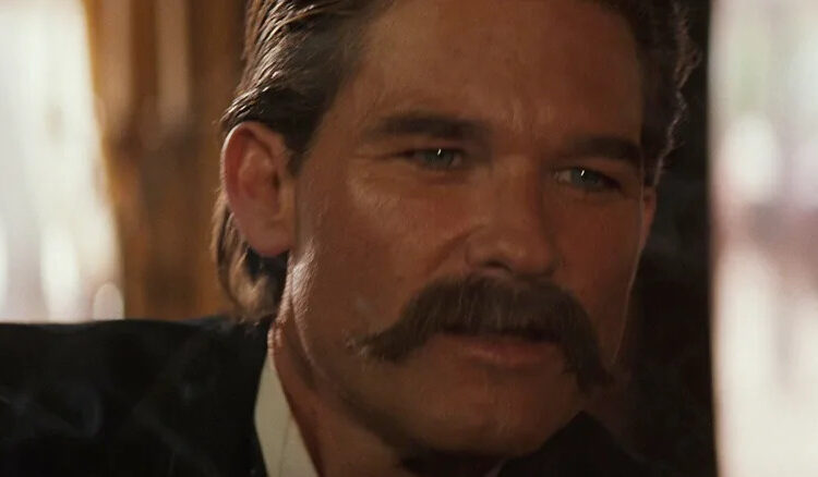 Kurt Russell as Wyatt Earp looking worried in Tombstone