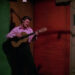 Elvis playing a guitar backstage in Elvis