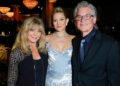 Goldie Hawn, Kate Hudson, and Kurt Russell pose together for a photo.