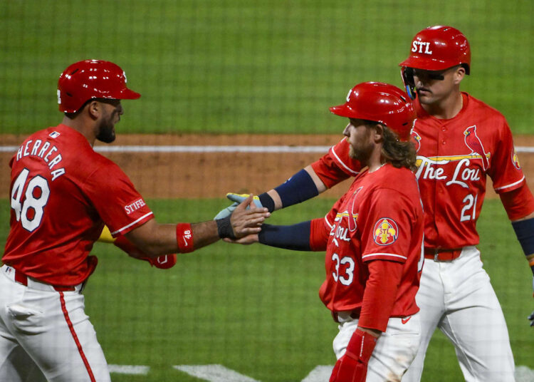 May 23, 2025; St. Louis, Missouri, USA;  St. Louis Cardinals designated hitter Ivan Herrera (48) right fielder Lars Nootbaar (21) and left fielder Brendan Donovan (33) celebrate after they scored on a three run triple by third baseman Nolan Arenado (not pictured) during the sixth inning against the Arizona Diamondbacks at Busch Stadium. Mandatory Credit: Jeff Curry-Imagn Images