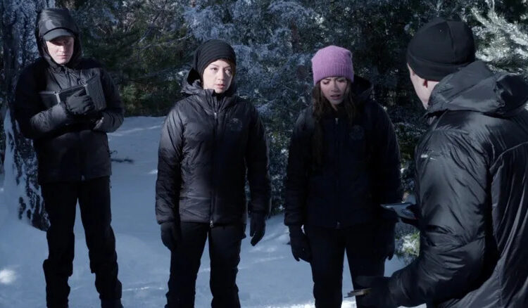 The cast of Agents of S.H.I.E.L.D. looking down while standing in the snow