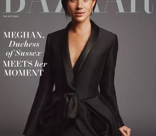 Meghan on the cover in a black suit