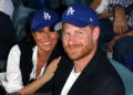 Prince Harry and Meghan Markle smile and pose at Dodgers game.