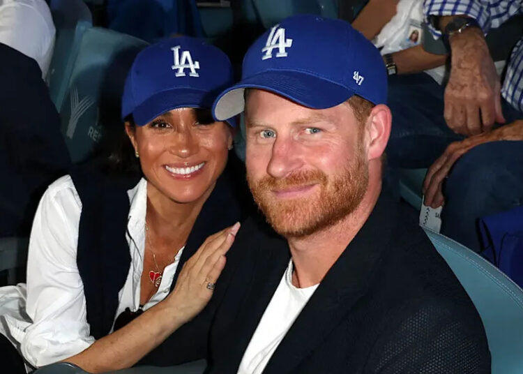 Prince Harry and Meghan Markle smile and pose at Dodgers game.