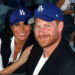 Prince Harry and Meghan Markle smile and pose at Dodgers game.