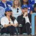 Meghan sat court-side at a World Series Baseball game with Prince Harry opting for an effortlessly chic ensemble of a crisp white Givenchy shirt, previously worn at the Endeavour Fund Awards, Veronica Beard jeans and a baseball hat