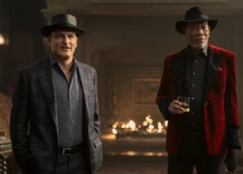Woody Harrleson as Merritt McKinney standing by Morgan Freeman as Thaddeus Bradley as he drinks whiskey in Now You See Me: Now You Don't