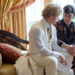 Matt Damon as Scott sitting on the sofa and holding hands with Michael Douglas as Liberace in Behind the Candelabra