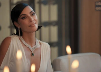 Kim Kardashian's Allura smiles as she sits at a table in All's Fair
