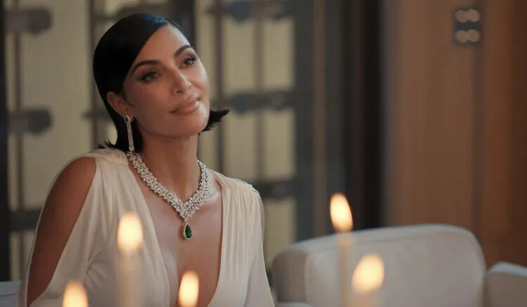 Kim Kardashian's Allura smiles as she sits at a table in All's Fair