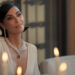 Kim Kardashian's Allura smiles as she sits at a table in All's Fair
