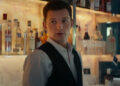 Tom Holland wearing tuxedo vest in Uncharted movie.