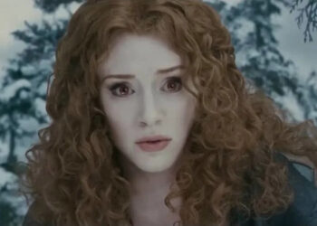 Bryce as Victoria stares intently in a wintery forest setting, appearing concerned or determined