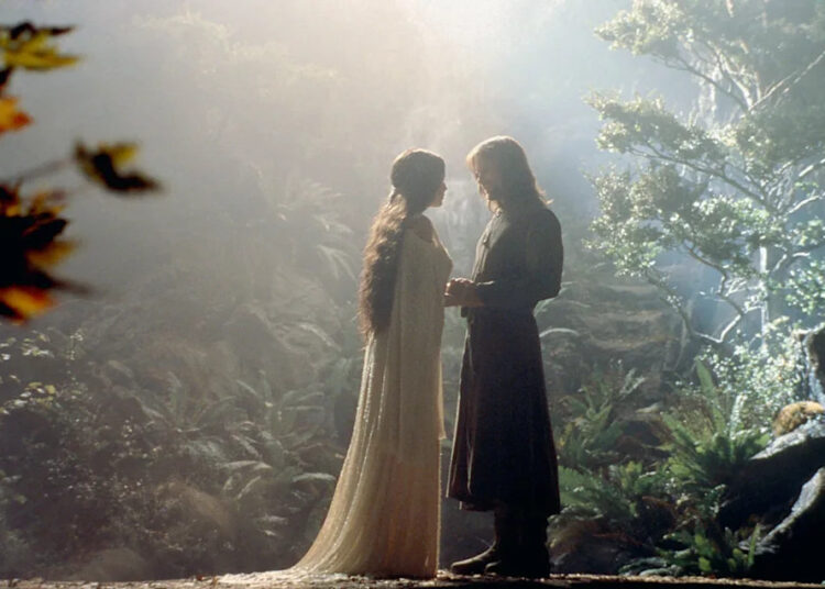 Two characters in flowing robes stand facing each other in a mystical forest setting, surrounded by lush greenery and soft, ethereal light