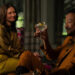 Karolina Wydra's Zosia and Samba Schutte's Koumba sitting and smiling on Pluribus