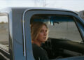 Rhea Seehorn's Carol Sturka sitting in a pickup truck on Pluribus
