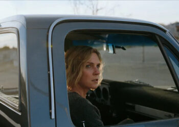 Rhea Seehorn's Carol Sturka sitting in a pickup truck on Pluribus