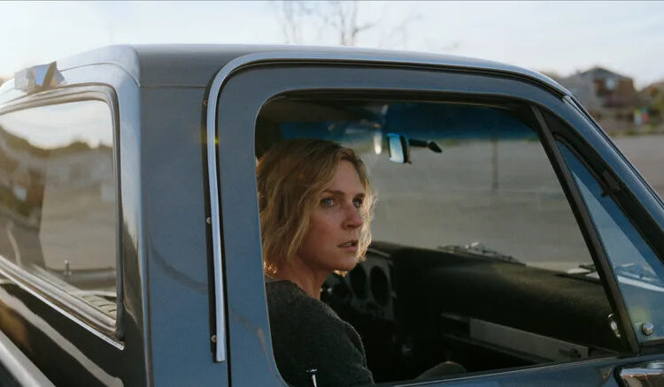 Rhea Seehorn's Carol Sturka sitting in a pickup truck on Pluribus