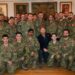 Prince Harry crouching with a group of soldiers