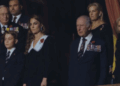 Prince George stands with The King and the Princess of Wales