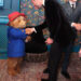 The Prince of Wales shakes hands with Paddington Bear from the London stage musical, alongside Tom Fletcher from McFly