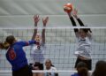 Peyton Mannin blocks a spike.