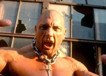 Bautista Leviathan character posing in front of broken windows on WWE television