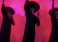 The Saja Boys perform against a red background in KPop Demon Hunters